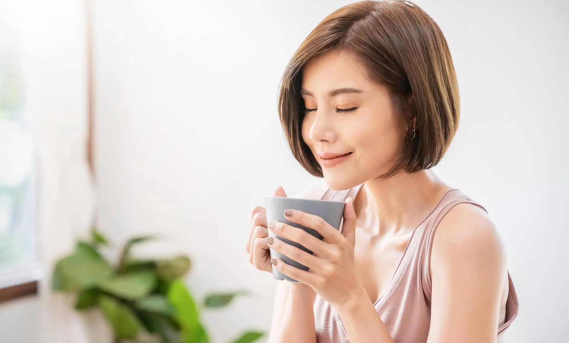 Young woman drinking chrysanthemum tea for heatiness